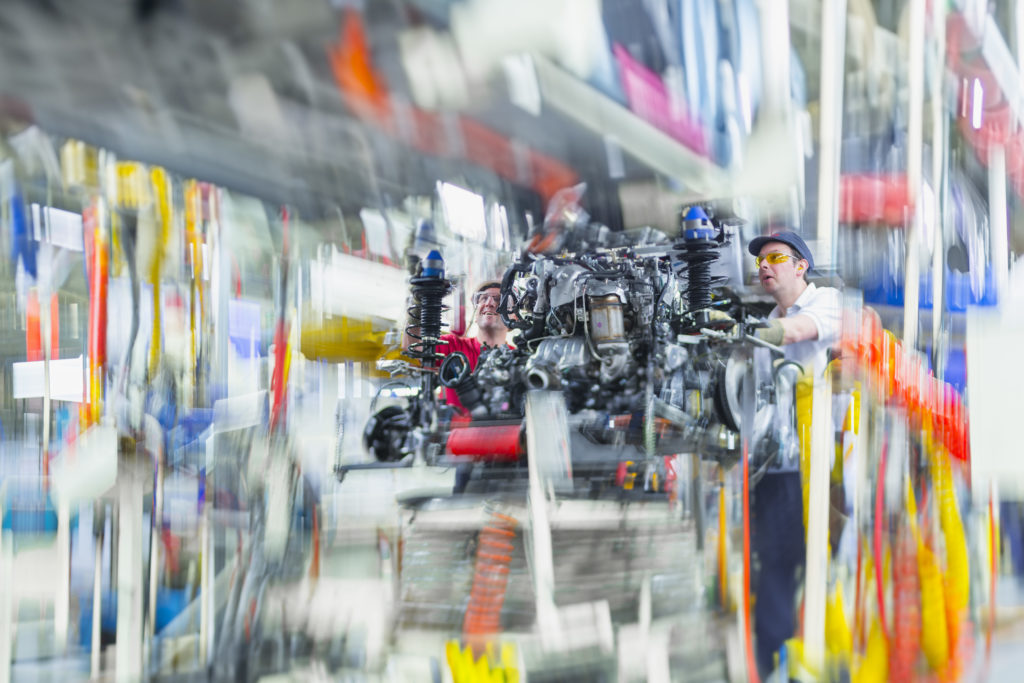 Two workers building a car for Toyota